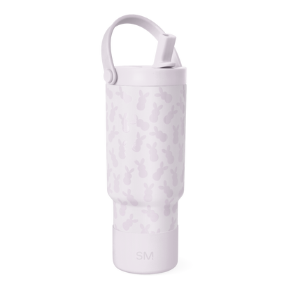Pale lavender bottle with darker mauve camouflage pattern, featuring a handle and top rim detail.